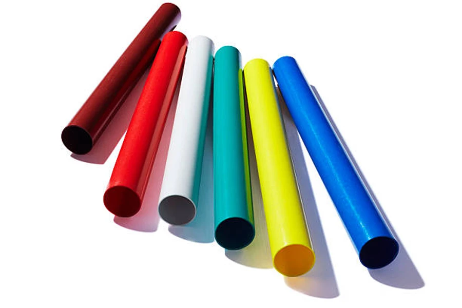 Six different colors of plastic relay batons on white background