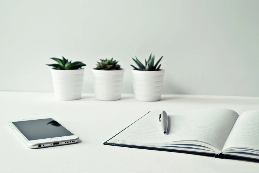 Three pots beside iPhone and a notepad