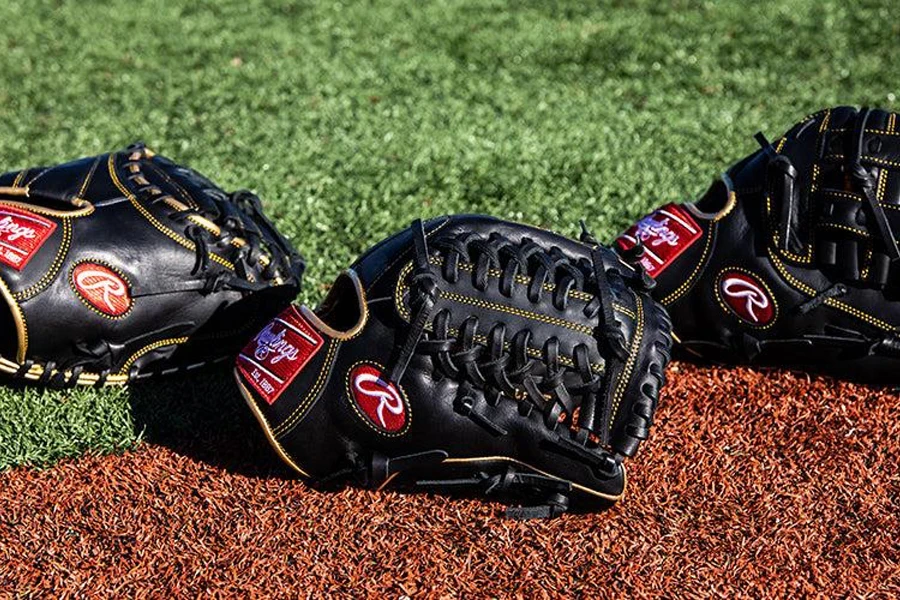 Three softball mitts on a playing field