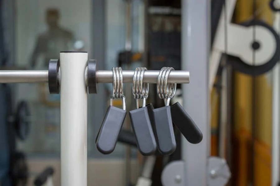 Three spring barbell collars hung on bar at gym