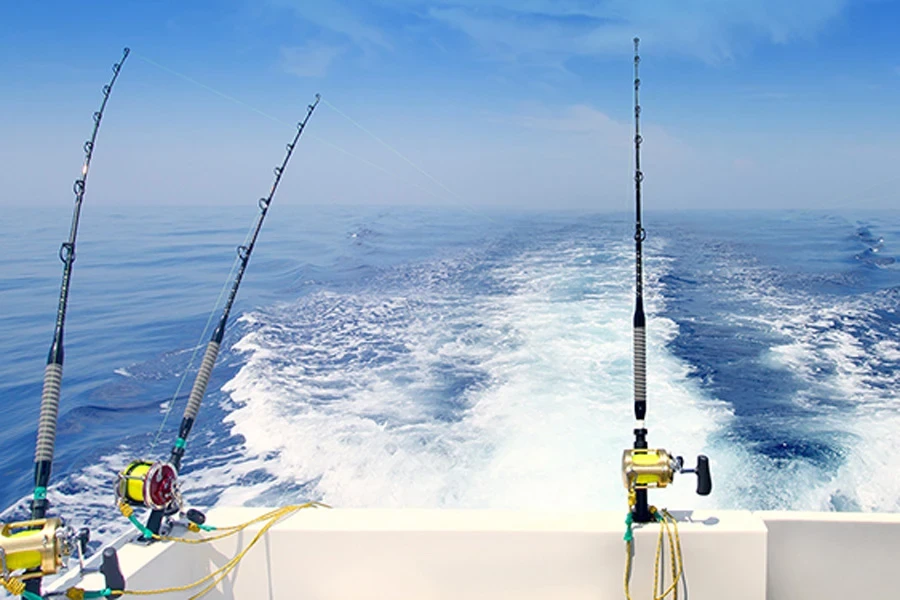 Three trolling fishing rods on a moving boat