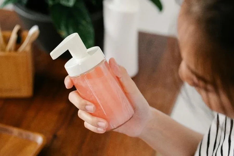 Woman holding foaming soap pump