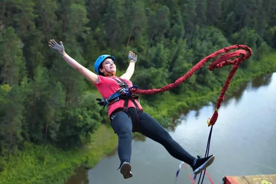 Woman jumping backward with a blue helmet