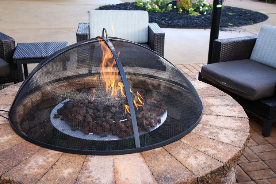 A fire pit sitting on a brick patio