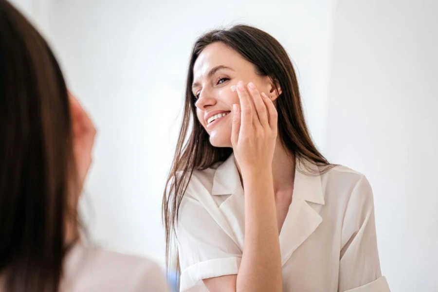 A woman applying a face cream