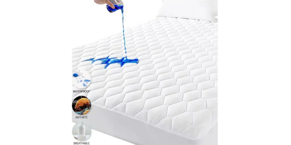 Hand pouring blue liquid onto a white padded mattress protector