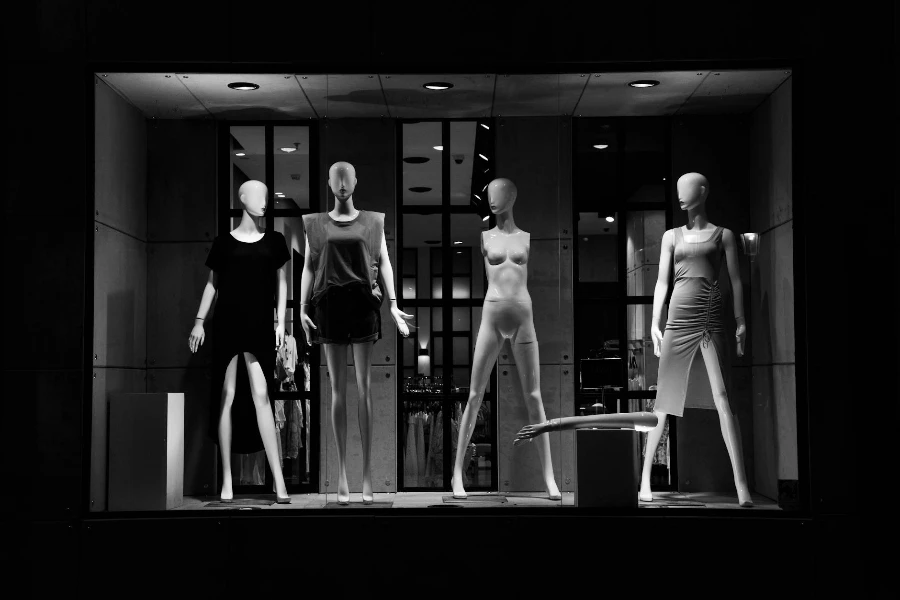 Grayscale Photo of Mannequins on Display Window