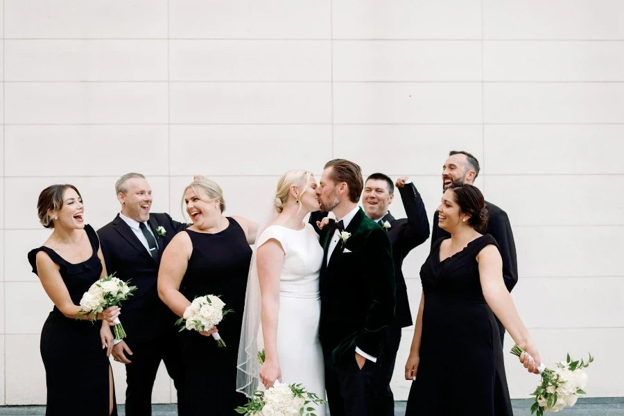 Newlyweds Kissing by Guests