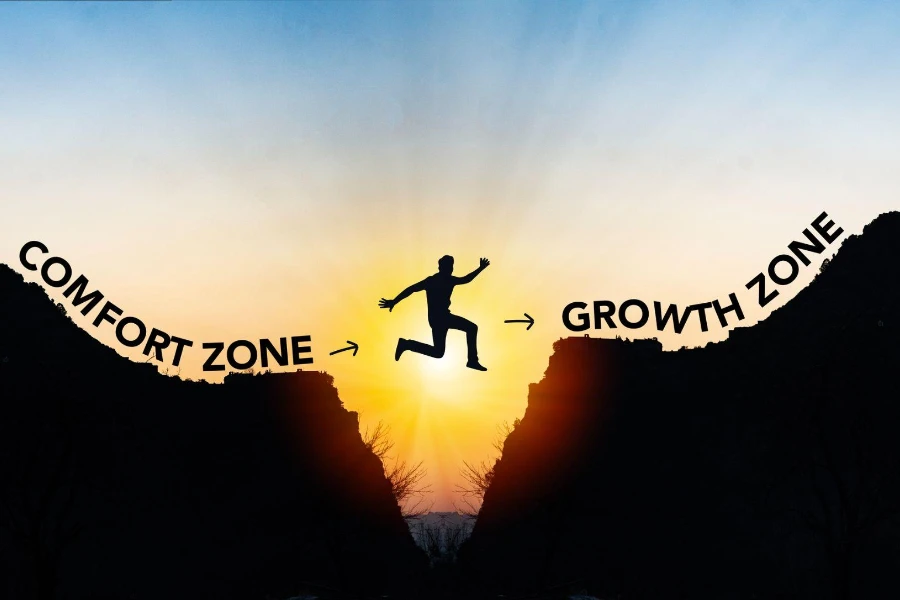 Mann springt von der Komfortzone in die Wachstumszone. Erfolgs- und Veränderungskonzept.