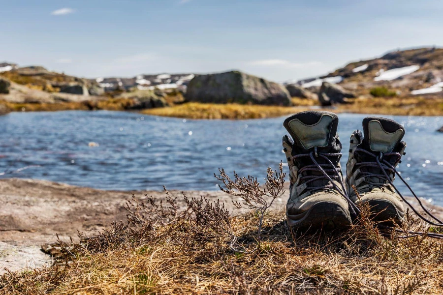 Mountain boots on a lake in the mountains