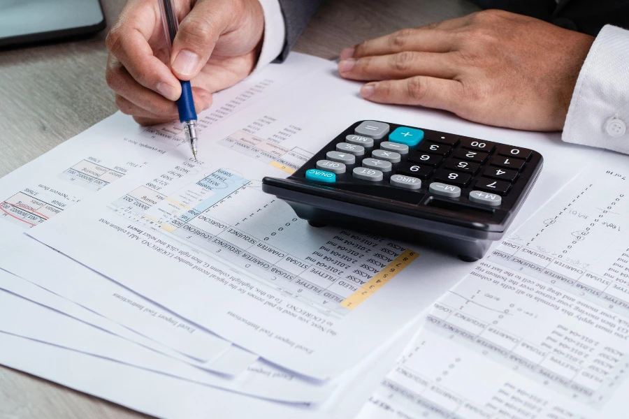 Cropped Image Of Businessman Calculating On Table