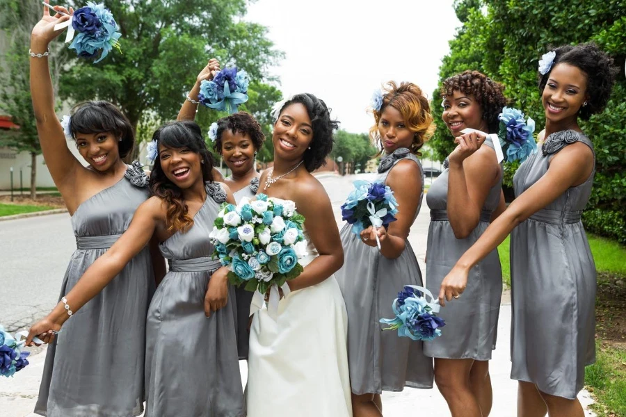 Bridesmaids helping the bride get dressed