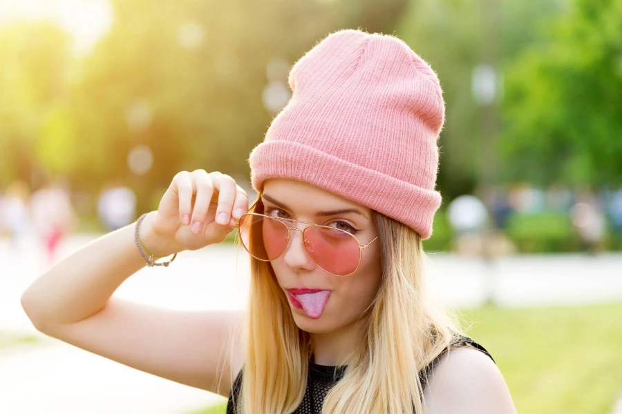 Hipster Girl en bonnet rose dans le parc