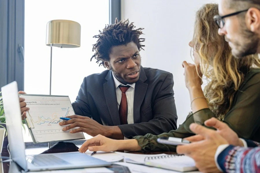 Professionals discussing data during a procurement negotiation session