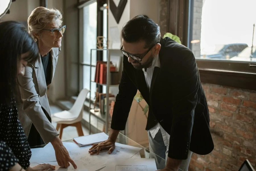 Two women and a man in a negotiation session