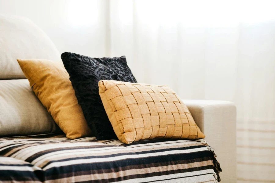 3 Cushions Stacked on a White Sofa