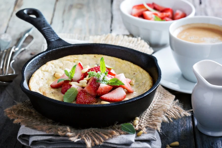 A black iron cast saucepan with food