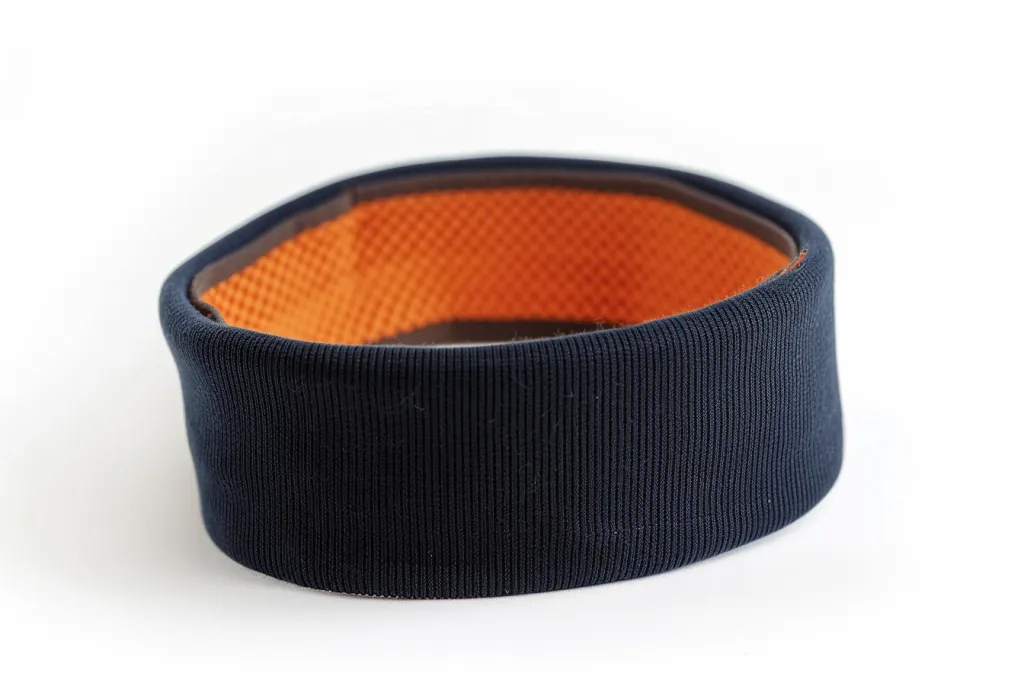 A navy blue sweatband with an orange inside