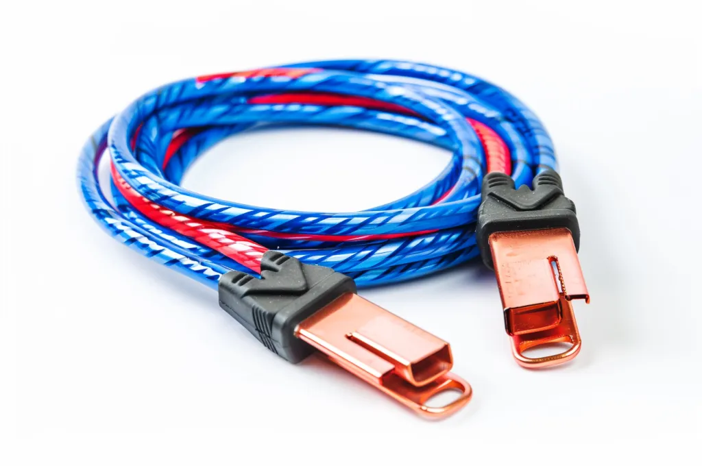A set of blue and red cables with copper clippers