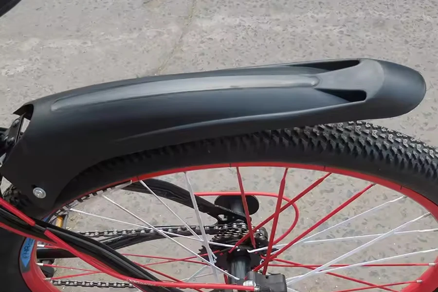 Black clip-on bicycle fender on back wheel of bike