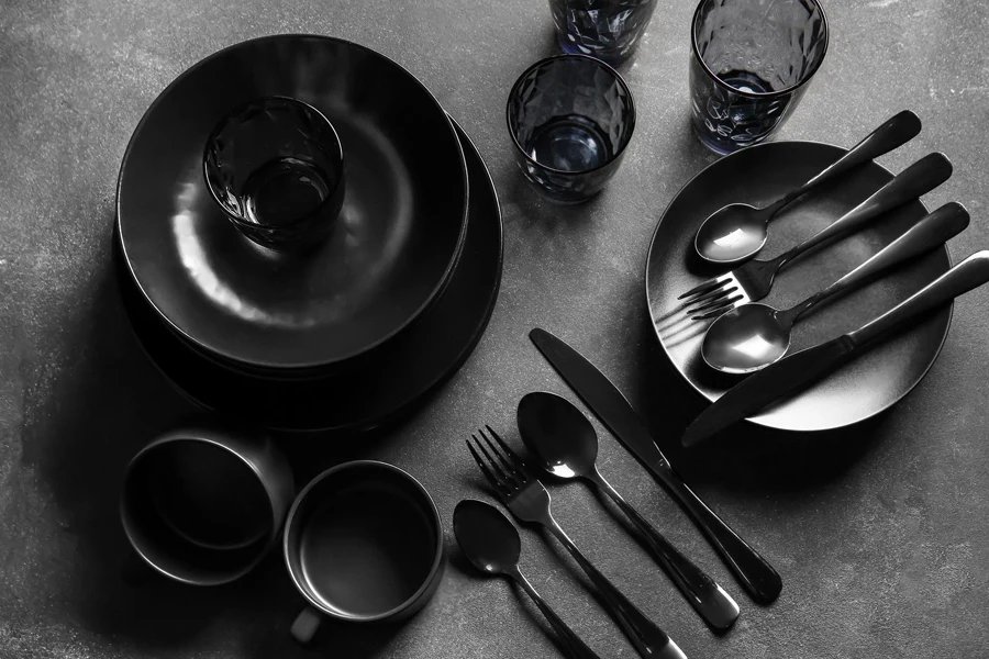 Black melamine plates, saucers, and cutlery