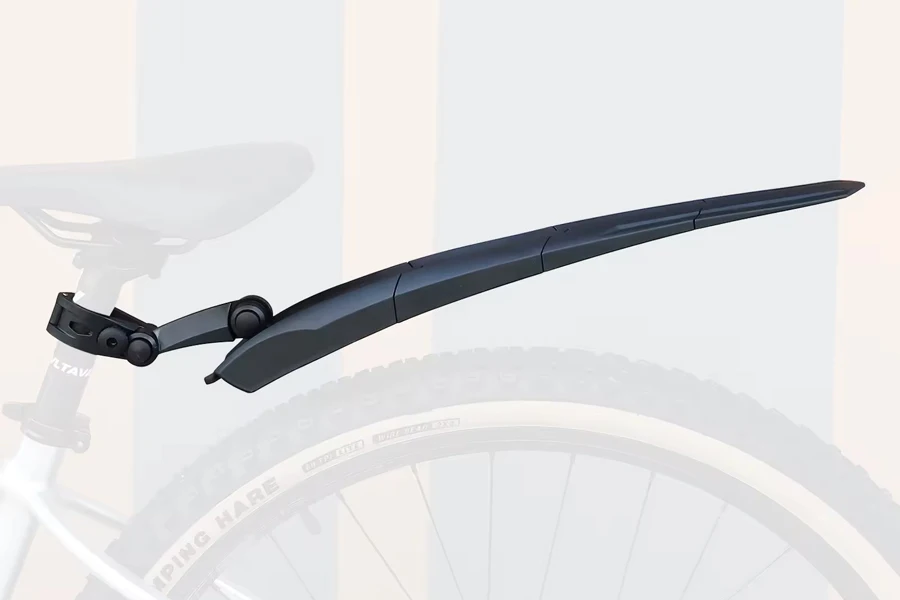 Black retractable bicycle fender at full extension on bike