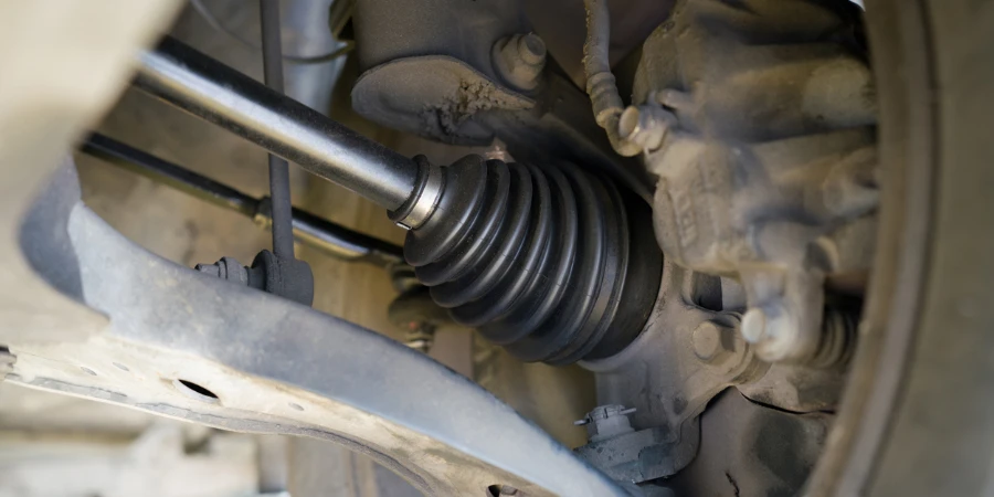 Closeup car's suspension system, focusing on the axle and CV joint area