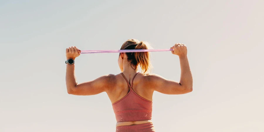Female athlete working out with resistance bands outdoors