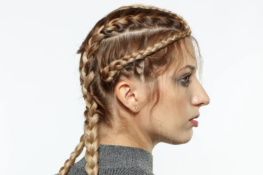 Female with creative braid hairdo on gray background