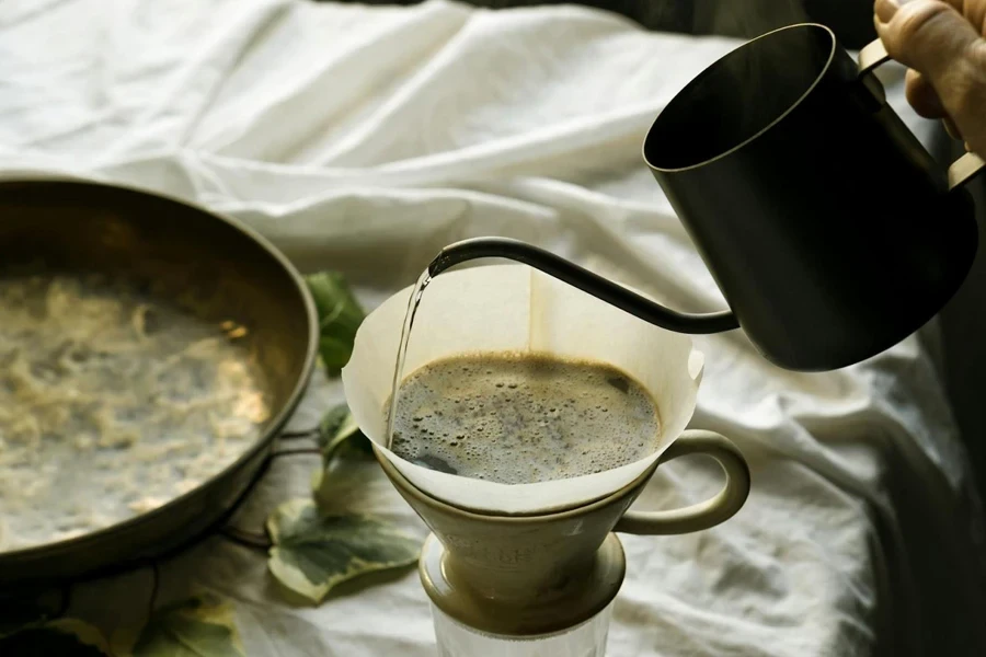 Hand pouring coffee into a filter