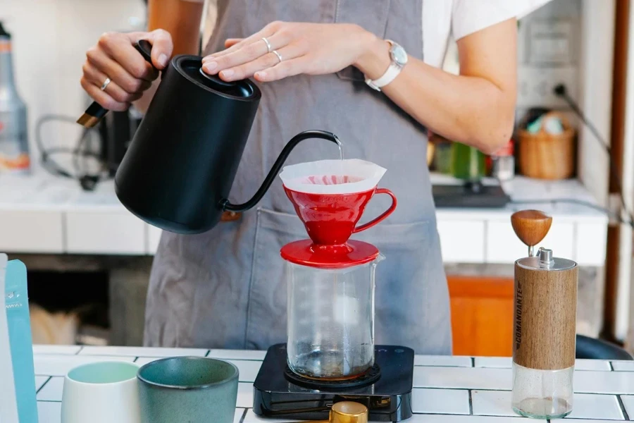 Lady pouring hot water into a filter