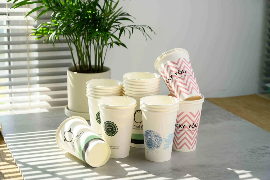 Several Paper Cups and a Plant on a Table