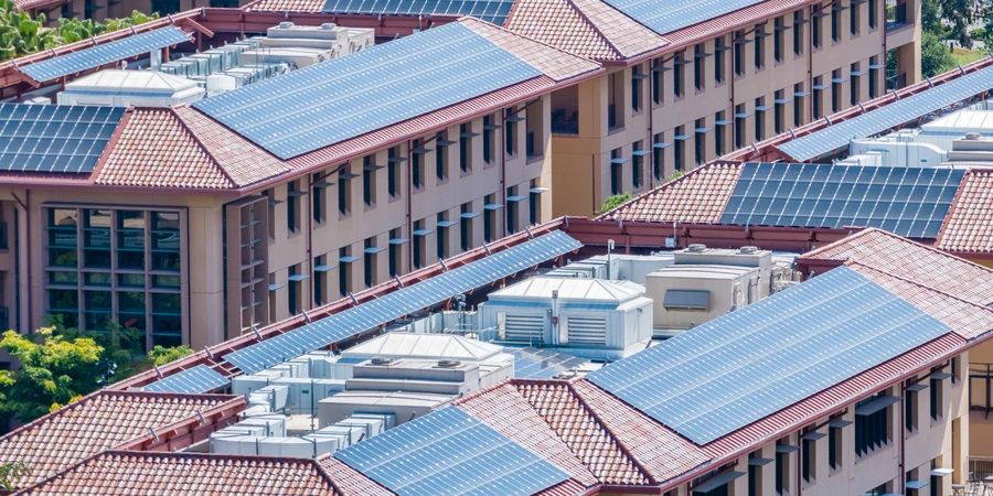Solar panels installed on the tiled rooftops of buildings
