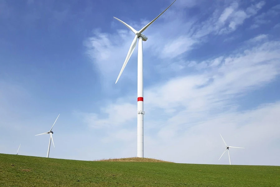 Tall wind turbines installed on a green field