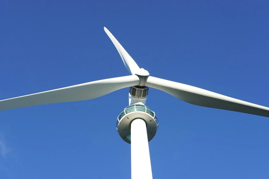 White wind turbine on a blue-sky background