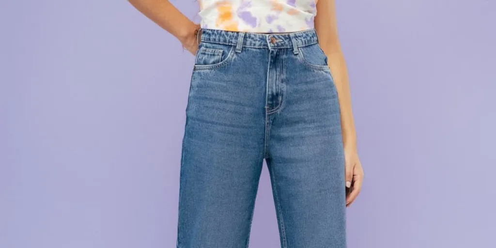 Woman with hand on waist wearing straight-leg jeans