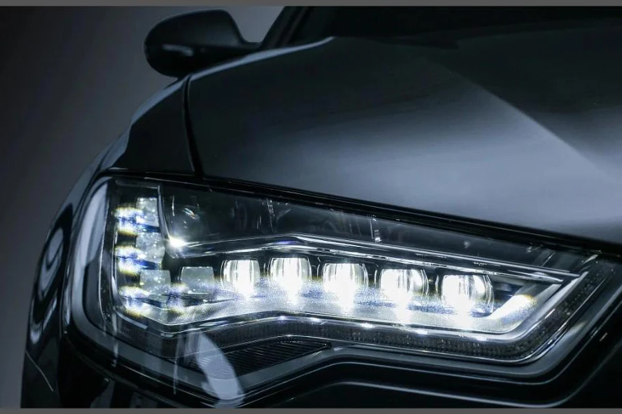a black sedan with a bright LED headlight