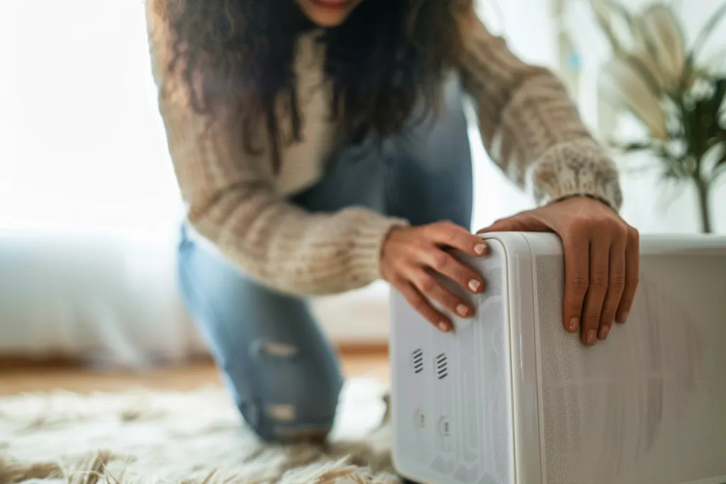 Close up of a woman using a dehumidifier in her home
