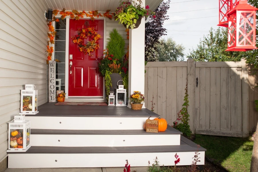 autumn front porch with Halloween pumpkins