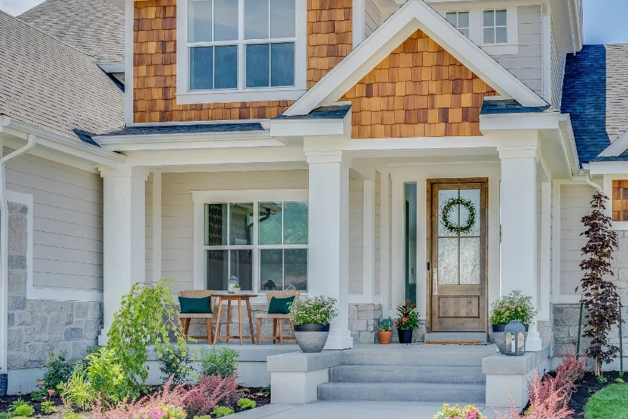 beautiful front porch with chairs and planters