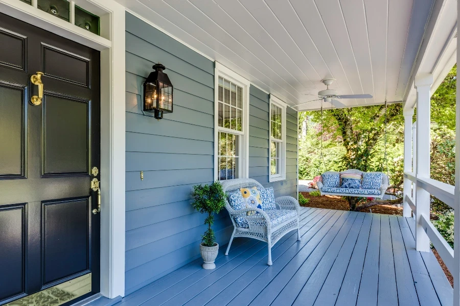 front porch with chairs and porch swing