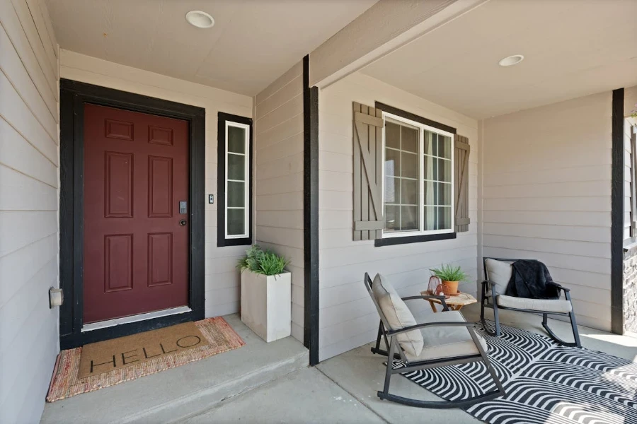 front porch with chairs and rug