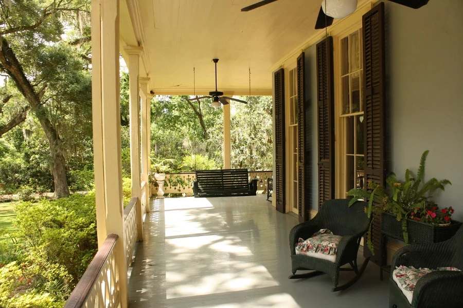 front porch with rocking chairs and flower bed