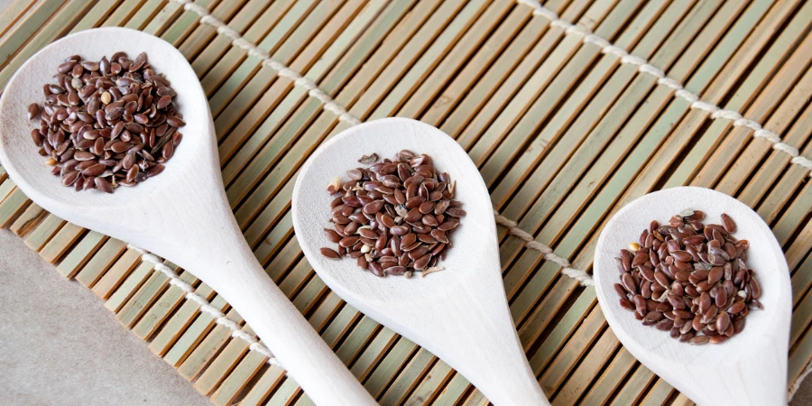 Flax seeds on three wooden spoons on the table