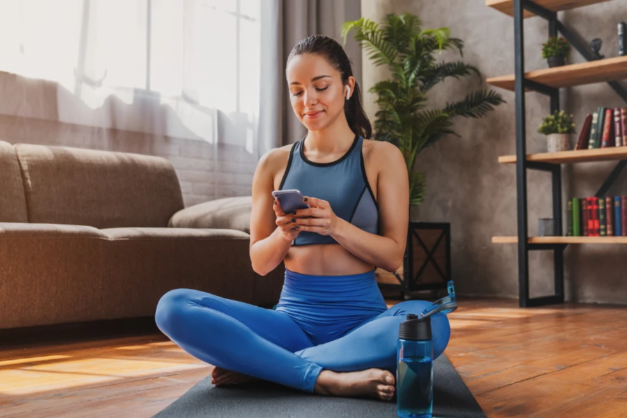 Beautiful woman using yoga go app