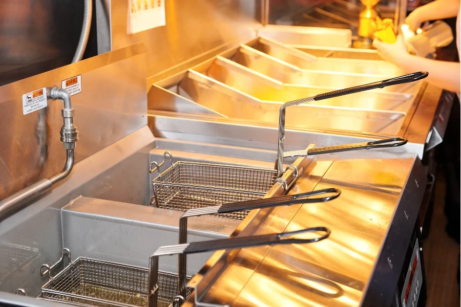 Deep fryer with boiling oil on restaurant kitchen
