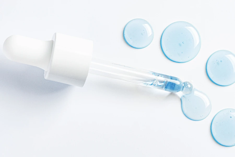 Drops of cosmetic serum and a pipette

