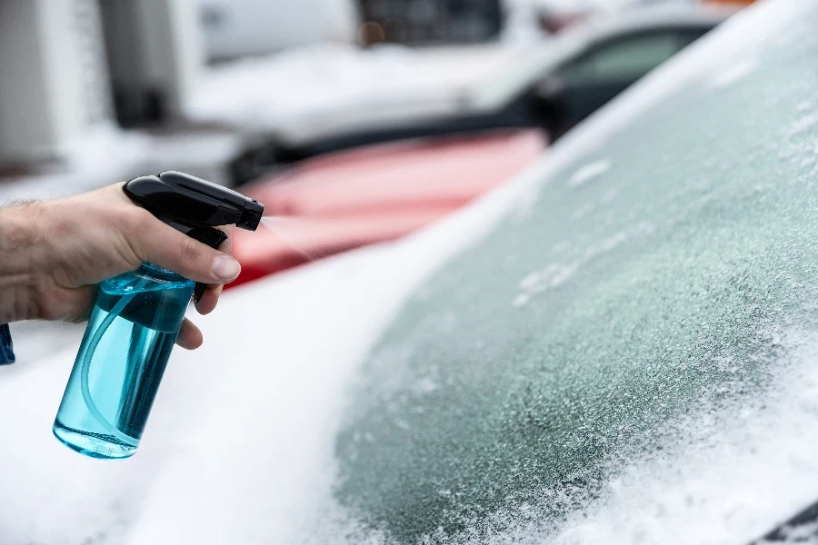 Man uses a bottle of de-icer