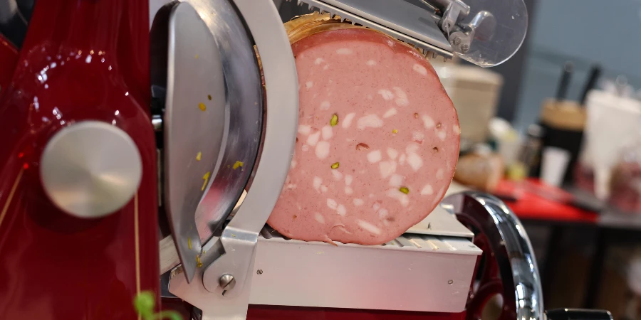 Mortadella ready to be cut on a professional slicer