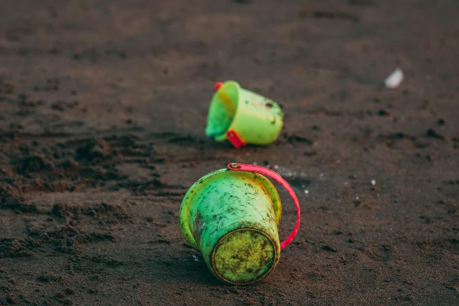 Two Green Pails on Ground